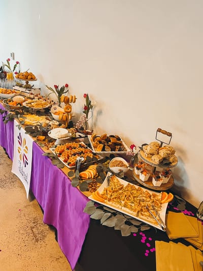 A beautifully arranged food table with various snacks and desserts