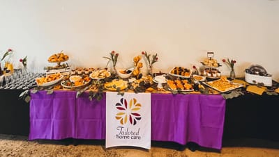 Catering setup for an event with a logo banner