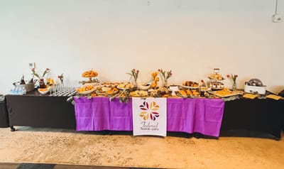 Buffet table with assorted pastries and drinks set up indoors