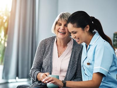 A caregiver and resident sharing a joyful moment