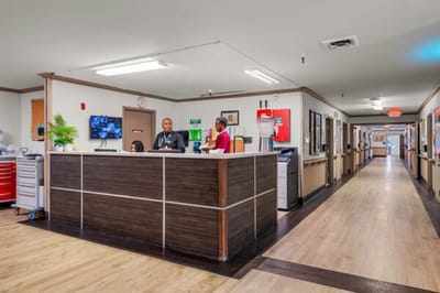 Reception area with staff members in a well-lit hallway