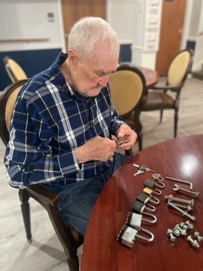 Resident engaged in an activity with locks and keys