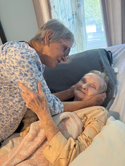 Two residents smiling and enjoying a moment together