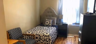 Cozy private resident room with bed and chair