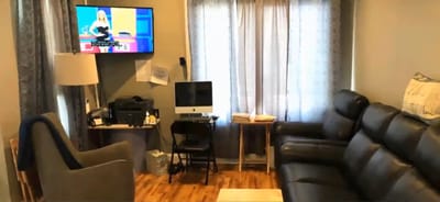 Cozy common area with seating and TV.