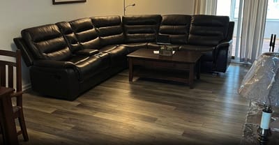 Cozy living area with black leather sectional sofa