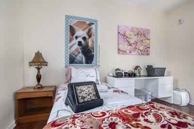 A cozy resident room with decor and a pet photo