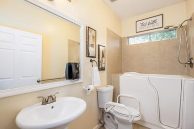 Accessible bathroom with walk-in tub and sink