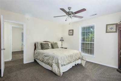 Comfortable bedroom with a queen-sized bed and natural light