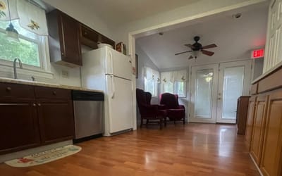 Well-lit kitchen area with seating and appliances