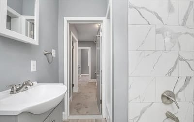 Modern bathroom interior with grey walls and marble tiles