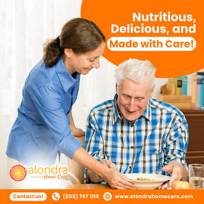 Caregiver serving food to a smiling senior man