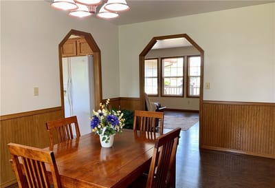 A dining area with wooden table and chairs