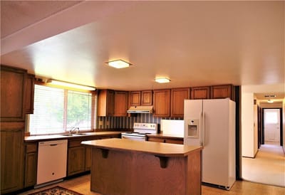 Bright kitchen interior with wooden cabinets and appliances