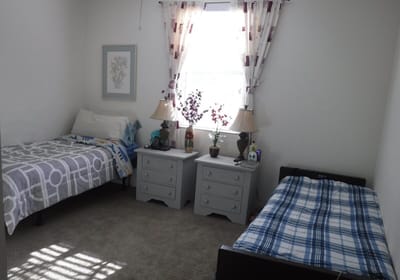 A shared resident room with two beds and decor