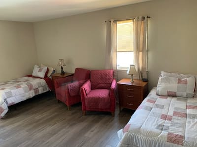 Private bedroom with two beds and seating