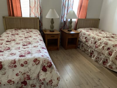 Simple interior room with two twin beds and lamps