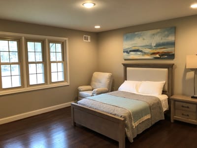 A well-furnished private resident room with bedding