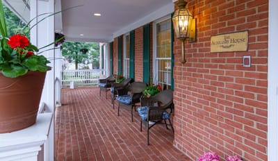 Welcoming porch area with seating at Auxiliary House