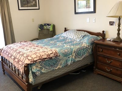 Cozy resident room with bed and dresser