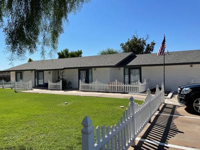 Exterior view of an assisted living facility with a yard