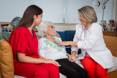 Caregiver interacting with a resident in a cozy setting