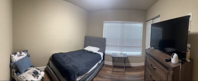 Cozy private resident room with a bed and TV
