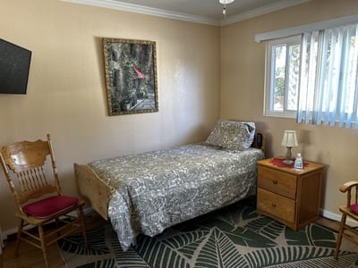 Cozy resident room with bed and armchair