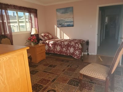 Cozy private bedroom with floral bedding and view