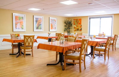 Bright dining room with tables and flowers