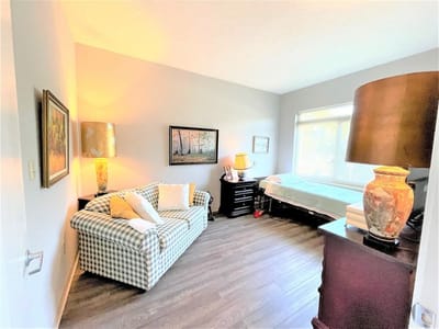 Cozy private resident room with a couch and lamp