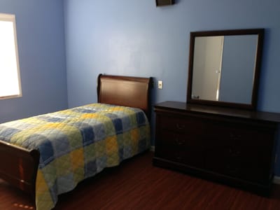 Cozy bedroom with a wooden bed and dresser