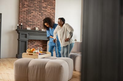Care worker assisting a resident in a cozy living room