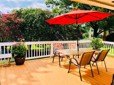 Outdoor patio with seating and vibrant flowers