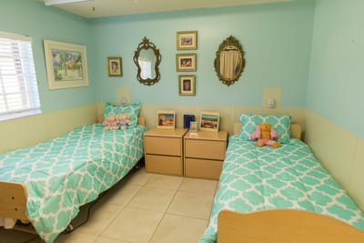Cozy resident room with pastel decor and twin beds