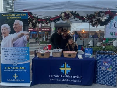 Staff and volunteers at a community event booth.