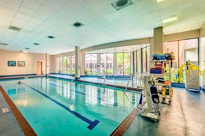 Indoor swimming pool with sunlight and lounge area