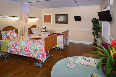 Interior of a shared resident room with beds and decor