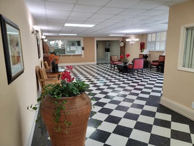 A clean interior common area with seating and decor