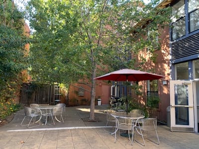 Outdoor courtyard with seating and an umbrella