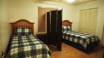 Shared resident room with two beds and privacy screen