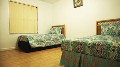 Cozy shared bedroom with two beds and patterned bedding