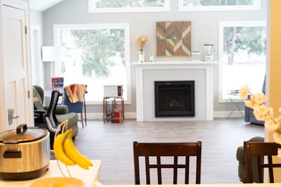Bright common area with seating and fireplace