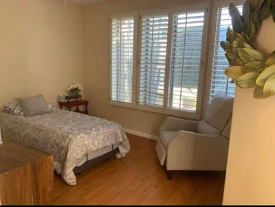 Cozy resident room with a bed and chair
