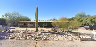 Exterior view of a senior care home with landscape