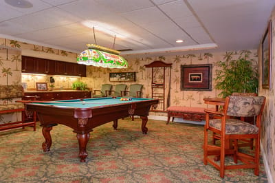 A common area with a pool table and seating