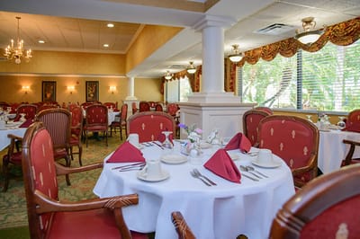 Dining room set for a meal with red decor