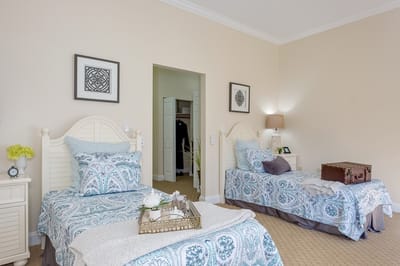 Cozy resident bedroom with two beds and decor