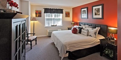 Well-furnished private resident room with a bed and decor