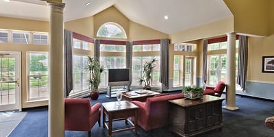 Bright common area with large windows and seating